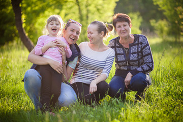 Fototapeta premium happy family sit in the grass with husky