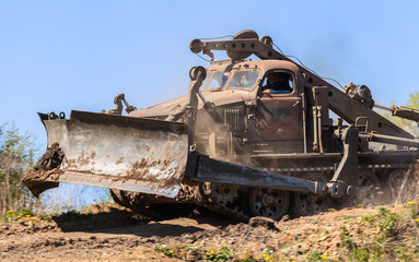 Fototapeta na wymiar soviet military bulldozer drives on track 