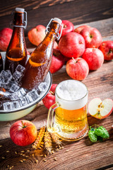 Cold and fresh cider beer with red apples