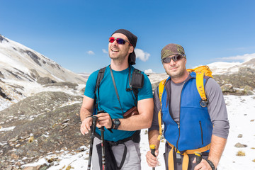 Tourists mountaineers standing top peak snow mountains.