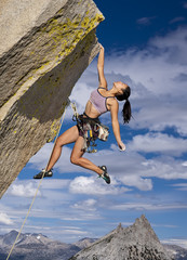 Rock climber clinging to a cliff.