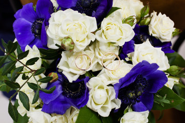 Beautiful bridal bouquet of flowers and wedding rings