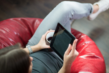 Woman reading an ebook at her home