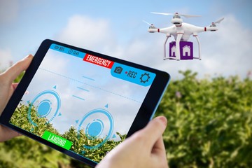 Composite image of hands holding tablet