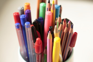 Container with pens and pencils