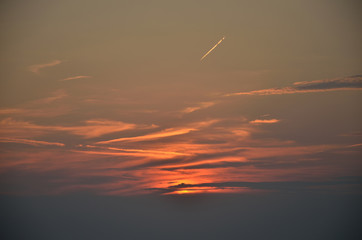 Sunset sky with plane trace