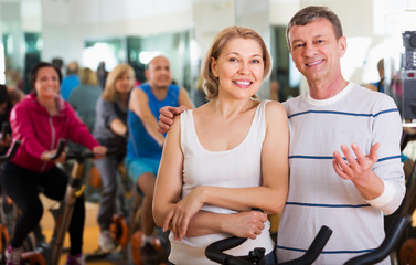Fototapeta premium Elderly couple exercising in gym