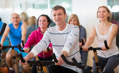 People cycling in a gym