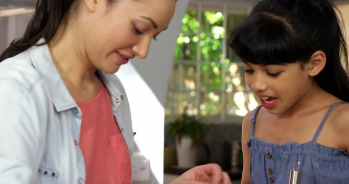 A mother and her little girl preparing pastries