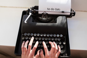 To do list: against womans hand typing on typewriter