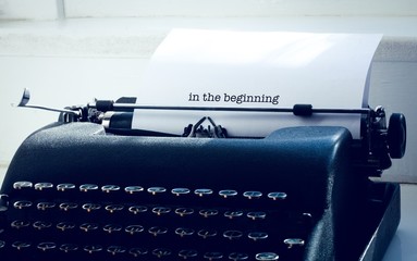 In the beginning against typewriter on a table