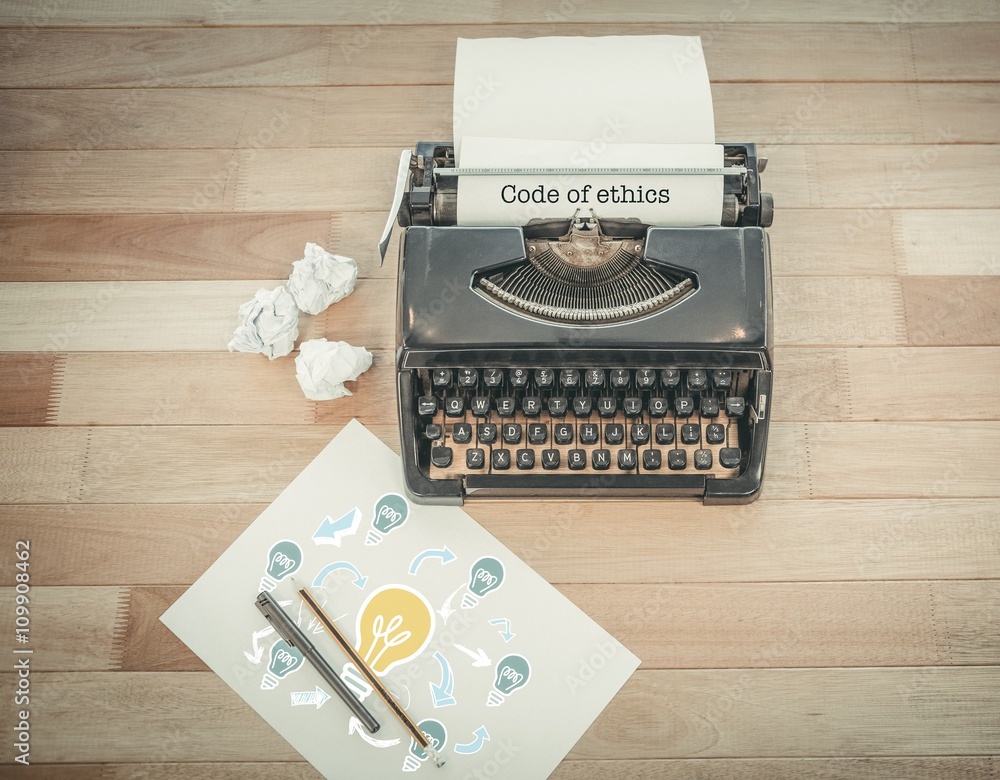 Aufkleber code of ethics against typewriter and paper on table in office