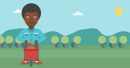 Obraz premium Man with plant and wheelbarrow.