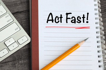 concept of act fast, with desk background