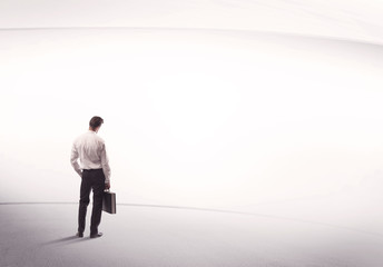 Fototapeta premium Businessman with briefcase standing still