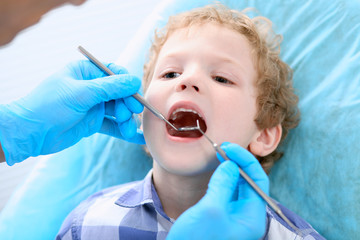 Close up of boy having his teeth examined by a dentist