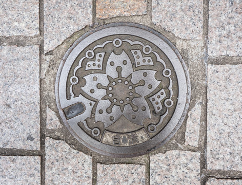 Circle steel manhole cover on polished stone