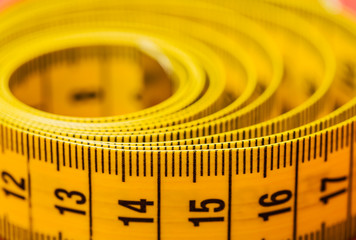 Measuring tape of the tailor on a colored background