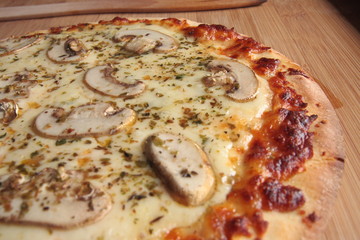 Four cheese pizza with fresh mushrooms on top
