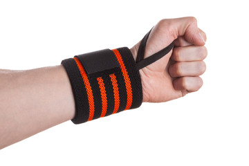 Calloused hand of a weightlifter with black and orange wrist wrap isolated on white background