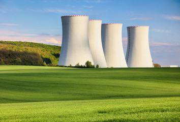 Nuclear power plant with green field.