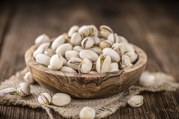 Whole Pistachios on wood
