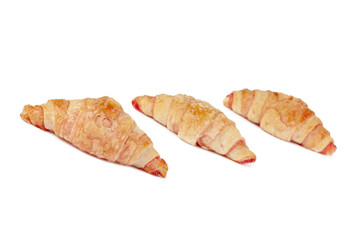 ham and cheese croissant arranged on a white background