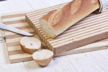 french baguette bread sliced on wooden board