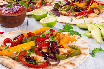 Homemade chicken burritos with vegetables, lime and salsa sauce