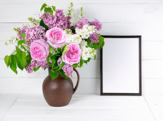 Lilac and roses in clay jug with motivational frame in scandinav