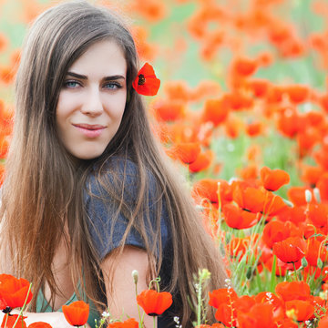 Beautiful woman outdoor at poppy field