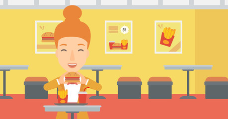 Woman eating hamburger. 