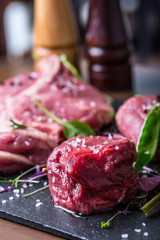 Steak.Beef steak.Meat.Portioned meat.Raw fresh meat.Sirloin steak.T-Bone steak. Flank steak. Duck breast. Vegetable decoration. Portioned meat prepared for processing in a restaurant or hotel kitchen.