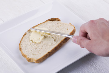 spreading butter on bread