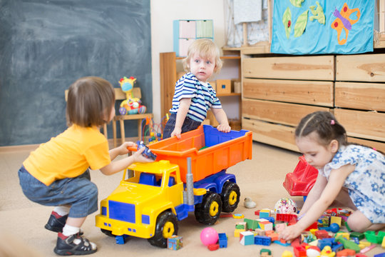 Two Kids Conflict Or Struggling For Toy Truck In Kindergarten