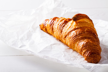 French pastry Croissant on white baking paper.