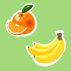 Orange fruit and bananas on green background