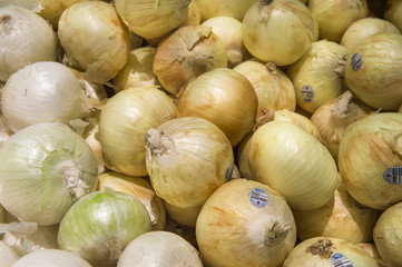 yellow onions crop from market shelves real with flaws and bruis