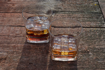 Two glasses of cola with ice