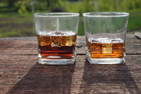 Two glasses of cola with ice