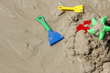 Fototapeta na wymiar Colorful Children's beach toys on sand