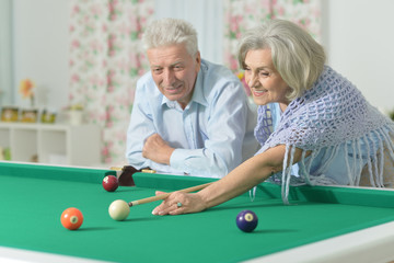 old couple playing billiard
