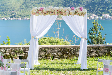arch for the wedding ceremony, decorated with cloth and flowers
