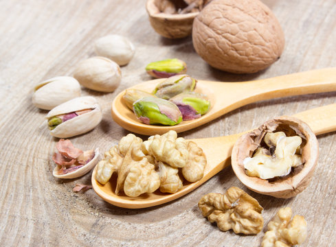 Closeup of a walnut and pistachios.