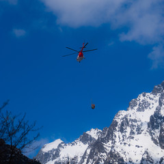 Naklejka na ściany i meble Helicopter at the mountains