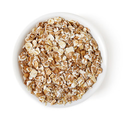 Bowl of oat flakes on white background, top view