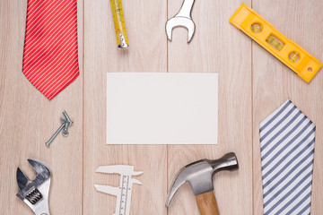 Happy Fathers Day Blank paper card with tools on a rustic wooden background