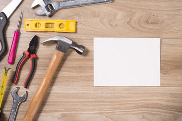 Happy Father's Day Blank paper card with tools on a rustic wooden background