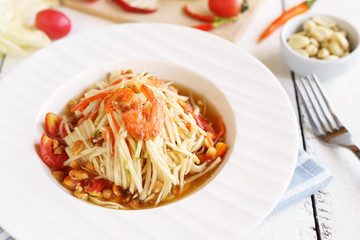 Papaya salad Famous Thai food on white wooden table