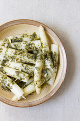 White asparagus on a beige plate, beige background. Spring on tha plate.